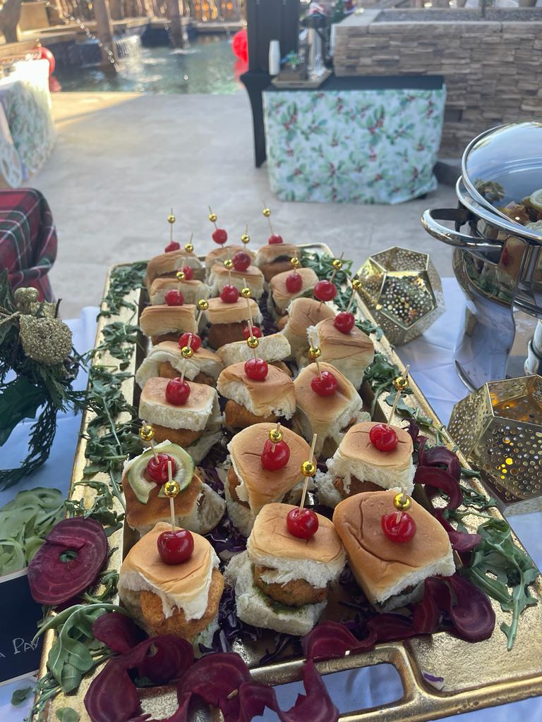 Cherry-topped mini sliders served poolside at dusk